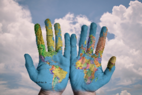 Photo of hands painted with a map of the world